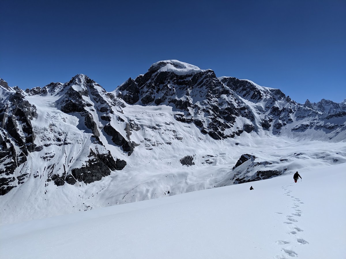 Trekkers crossing snow below Deo Tibba base camp